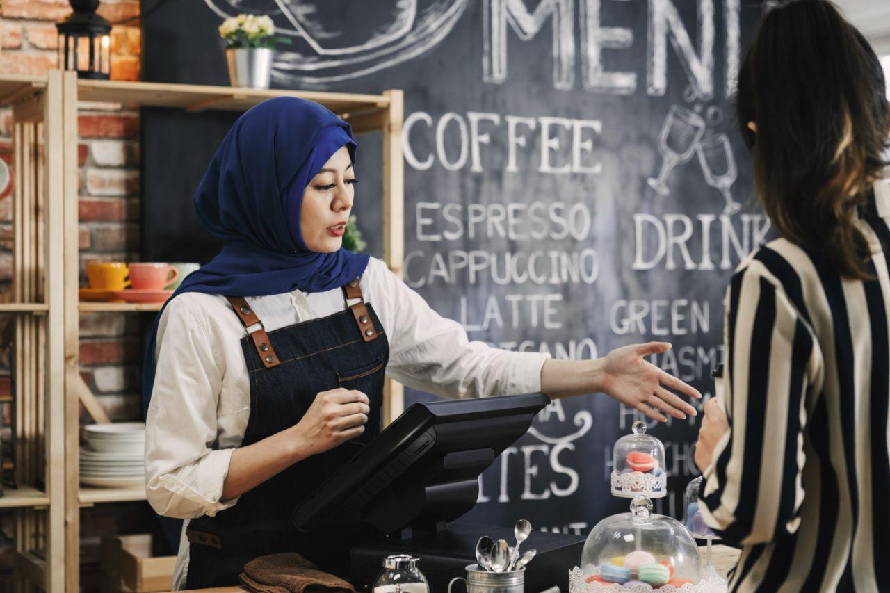 Illustrative image of persons at cashier counter in a café